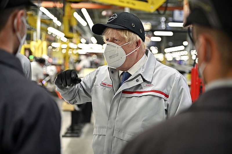 Britain's Prime Minister Boris Johnson during his visit to Nissan plant in Sunderland, England, Thursday July 1, 2021. Johnson said unspecified “extra precautions” will be needed in coming weeks even as he voiced confidence Thursday that the remaining restrictions on social contact in England will be lifted on July 19. During a visit to the Nissan car plant in the north England city of Sunderland, Johnson said he is planning to reveal details of what the end of lockdown restrictions will look like in the coming days. (Jeff J Mitchell/Pool Photo via AP)