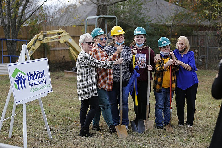 Neaomie Ryan (from right) hugs Lyric Cote, 10, as he stands with his sister Zoe Griffis, mother Angela Sockrider, Sockrider‚Äôs mother Diana Holmes and aunt Linda Look Monday, November 9, 2020, during a Habitat for Humanity of Benton County ground breaking event for a new home for Sockrider at 808 N. 31st Street in Rogers. Check out nwaonline.com/201126Daily/ and nwadg.com/photos for a photo gallery.(NWA Democrat-Gazette/David Gottschalk)