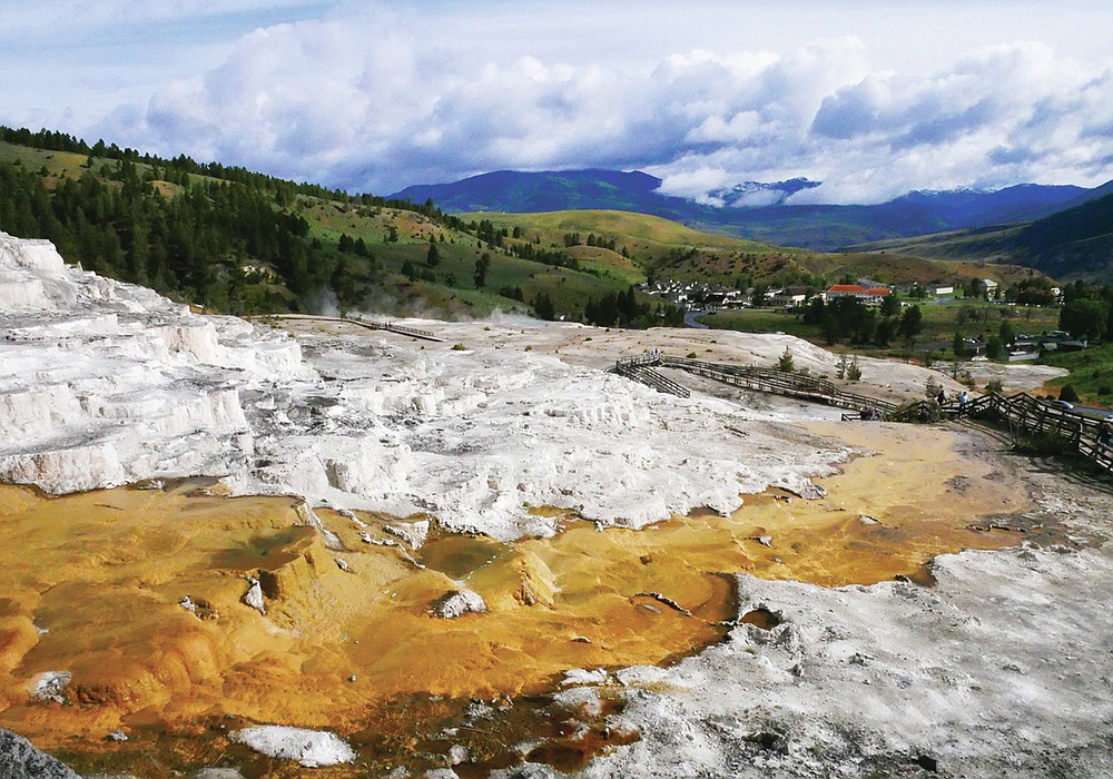 This June 17, 2017 image shows Mammoth Hot Springs in Yellowstone National Park in Wyo. The first episode of the Parks podcast highlights stories of Native American tribal members who live near the Yellowstone area. (Matt Dahlseid/Santa Fe New Mexican via AP)