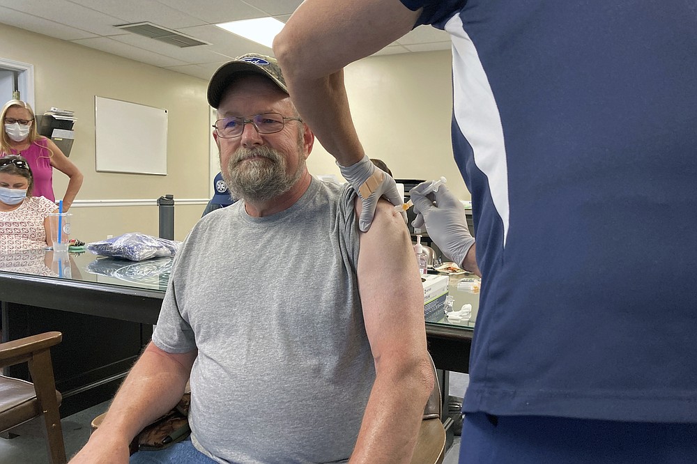 John Rogers receives a second dose of the COVID-19 vaccine in Taylorsville, Ky., on Thursday, June 17, 2021. Rogers waited months after becoming eligible for the COVID-19 vaccine. It was only after talking with friends that the retiree was persuaded to get the shot. “They said, ‘You know, the vaccine may not be 100%, but if you get COVID, you’re in bad shape,'" Rogers said. “You can die from it." (AP Photo/Dylan Lovan)