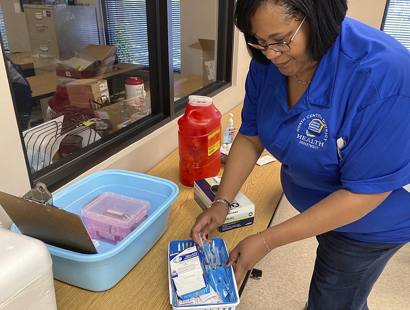 Roanya Rice, public health director, Central District Health Department prepares COVID-19 vaccines in Shelbyville, Ky., on Friday, June 18, 2021. With the U.S. falling short of President Joe Biden’s goal of having 70% of all American adults at least partially vaccinated by the Fourth of July, public health officials in places like Spencer County, have shifted the emphasis. (AP Photo/Dylan Lovan)