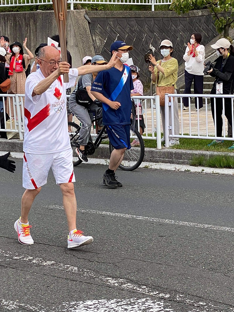 Masanori Kashiwaba runs with the Olympic torch in Shiwa Town, Japan. - Submitted photo