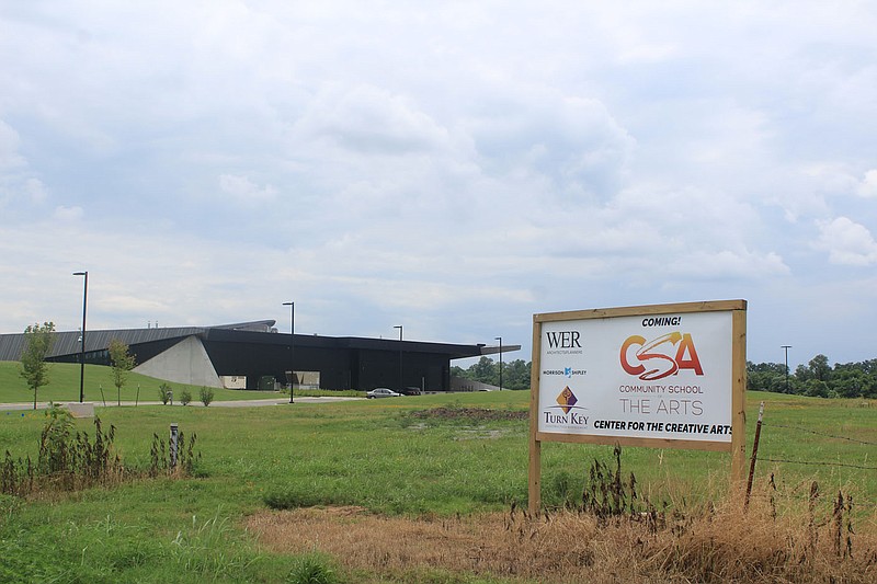 The construction sign for Community School of the Arts is seen next to the U.S. Marshals Museum Friday, July 2, 2021, on the Fort Smith riverfront.