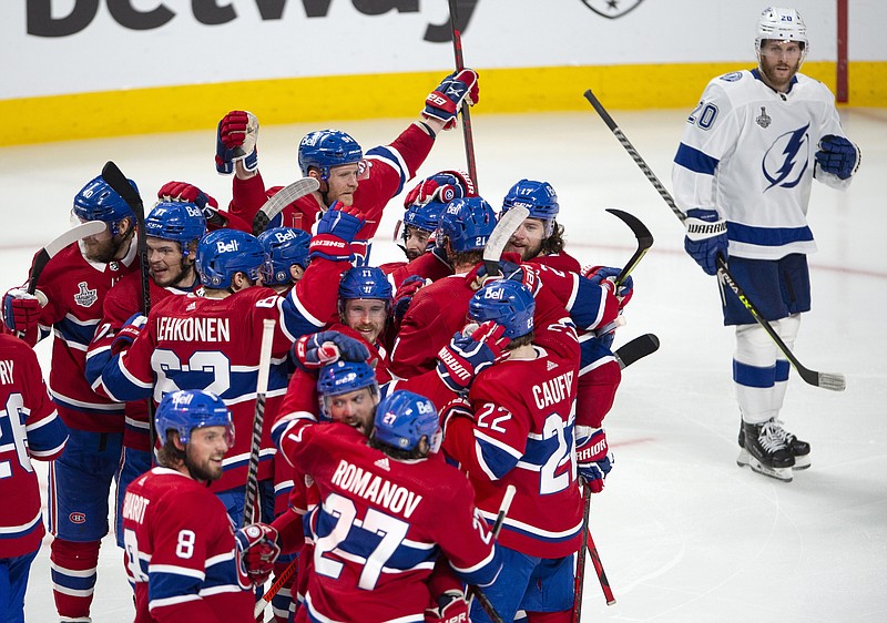 Tampa Bay Lightning's Blake Coleman (20) looks on as Montreal Canadiens celebrate teammate Josh Anderson's (17) winning goal at the end of overtime of Game 4 of the NHL hockey Stanley Cup final in Montreal, Monday, July 5, 2021. (Ryan Remiorz/The Canadian Press via AP)