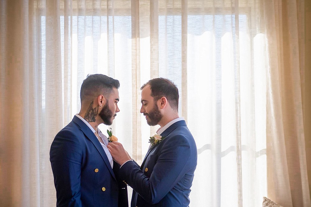 Michael DeSalvo Solarte (left) and her husband Alejandro Solarte DeSalvo share a moment on June 25 before their ceremony. The couple had postponed their plans to marry until 2022, but won a trip to get married at the Carneros Resort and Spa in Napa Valley, California thanks to the non-profit Visit California. (Special to the Democrat-Gazette / Max Whittaker)