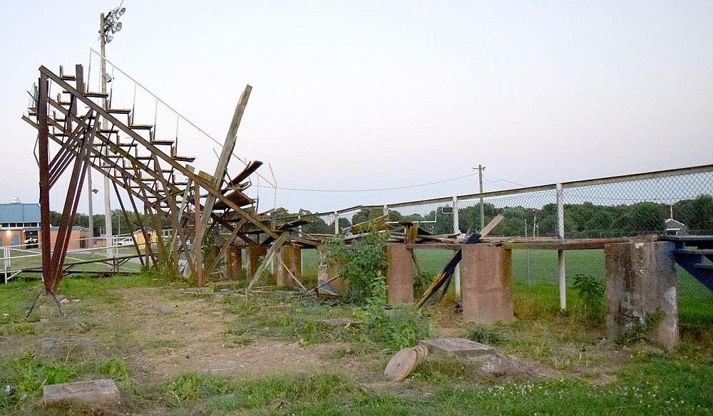 Westside Eagle Observer/MIKE ECKELS
By late afternoon Thursday all but one section of seats and the walkway were the only part of the 31 year old Bulldog Stadium wood bleachers. The Decatur landmark was taken down to make way for a new set of bleachers purchased from the Farmington School District in May.