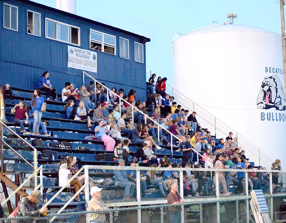 Westside Eagle Observer/MIKE ECKELS
The bleachers at Bulldog Stadium in Decatur were filled with middle and high school band members and fans during the open game of the eight-man football season August 30, 2019. This Decatur landmark was disassembled July 9 to make way for a new set of aluminum bleachers.