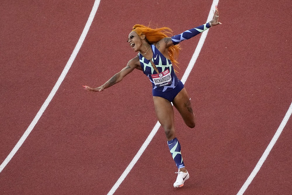 Sha'Carri Richardson celebrates after winning the women's 100-meter run at the U.S. Olympic Track and Field Trials Saturday, June 19, 2021, in Eugene, Ore.(AP Photo/Charlie Riedel)