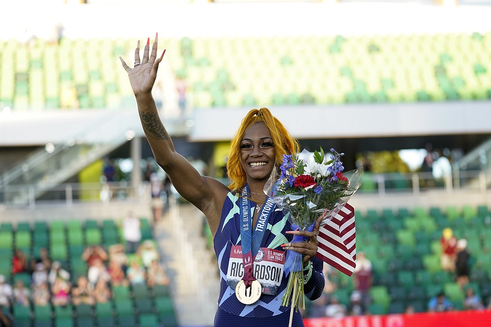 Sha'Carri Richardson waves after winning the women's 100-meter run at the U.S. Olympic Track and Field Trials Saturday, June 19, 2021, in Eugene, Ore. (AP Photo/Ashley Landis)