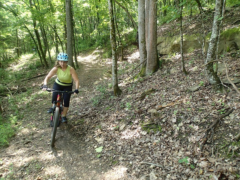 SueEllen Novick cruises through the forest June 11 2021 on the Marble Flats trails minutes from downtown Eureka Springs. Novick samples the "Beauty Is Everywhere" loop that guides riders past rock formations, a skills area and acres of woods.
(NWA Democrat-Gazette/Flip Putthoff)