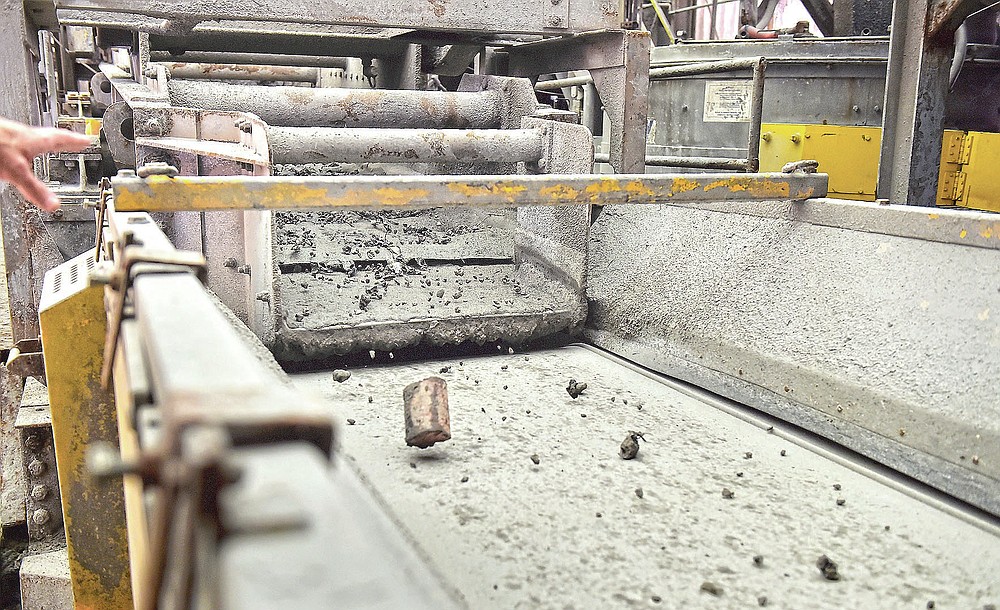 Ash, cans, metal and other debris moves on a conveyor belt after a cool down period during a tour of the Lancaster County Solid Waste Management Authority's waste-to-energy facility in Bainbridge, Pa., Wednesday, June 16, 2021. (Suzette Wenger/LNP/LancasterOnline via AP)