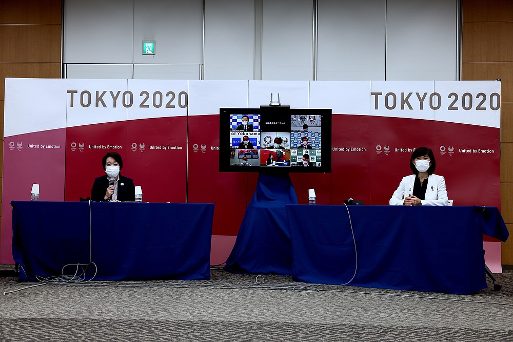 Tokyo 2020 president Seiko Hashimoto, left, and Tokyo Olympics Minister Tamayo Marukawa attend the local municipalities working group meeting in Tokyo, Thursday, July 8, 2021. (Behrouz Mehri/Pool Photo via AP)