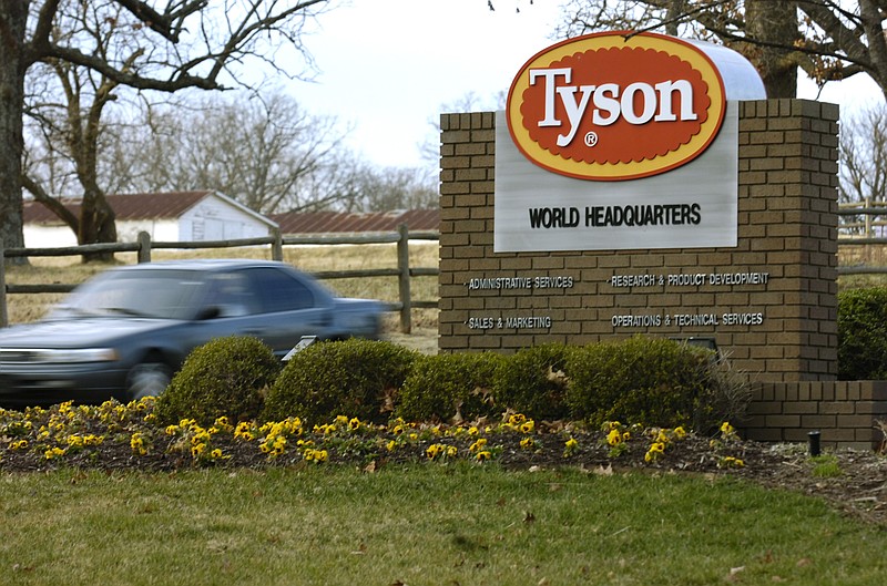 FILE - In this Jan. 29, 2006, file photo, a car passes in front of a Tyson Foods Inc., sign at Tyson headquarters in Springdale, Ark. Tyson Foods is recalling almost 4,500 tons of ready-to-eat chicken products after finding the products may be tainted with listeria bacteria. The U.S. Department of Agriculture announced the recall Thursday, July 8, 2021 after two consumers reported falling ill with listeriosis. (AP Photo/April L. Brown, File)