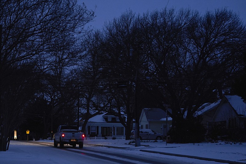 A truck drives down the street during a power outage in McKinney, Texas, on Feb. 16, 2021. MUST CREDIT: Bloomberg photo by Cooper Neill.