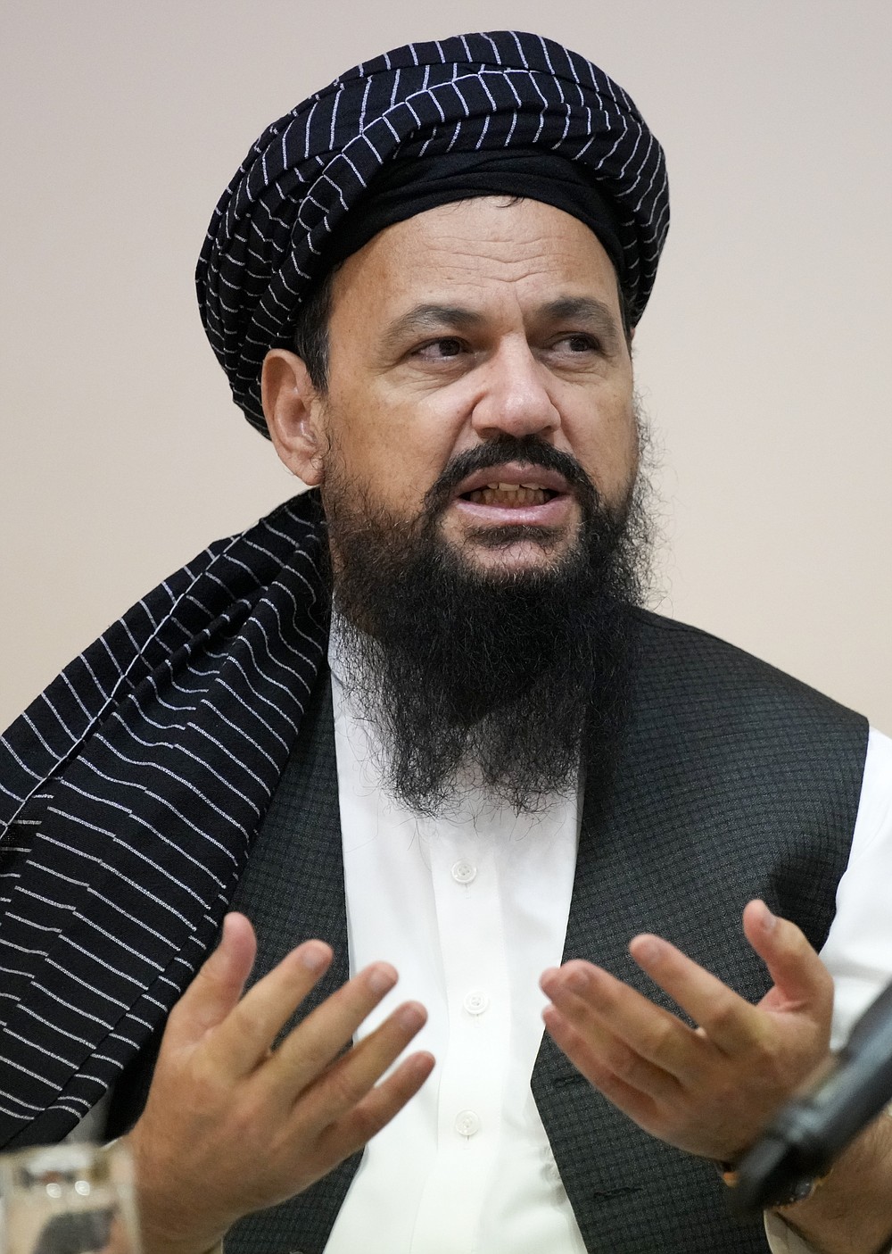 Dr, Mohammad Naim, member of political delegation from the Afghan Taliban's movement gestures during a news conference in Moscow, Russia, Friday, July 9, 2021. (AP Photo/Alexander Zemlianichenko)