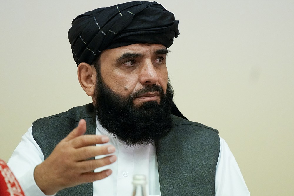 Suhil Shaheen, member of political delegation from the Afghan Taliban's movement gestures during a news conference in Moscow, Russia, Friday, July 9, 2021. (AP Photo/Alexander Zemlianichenko)