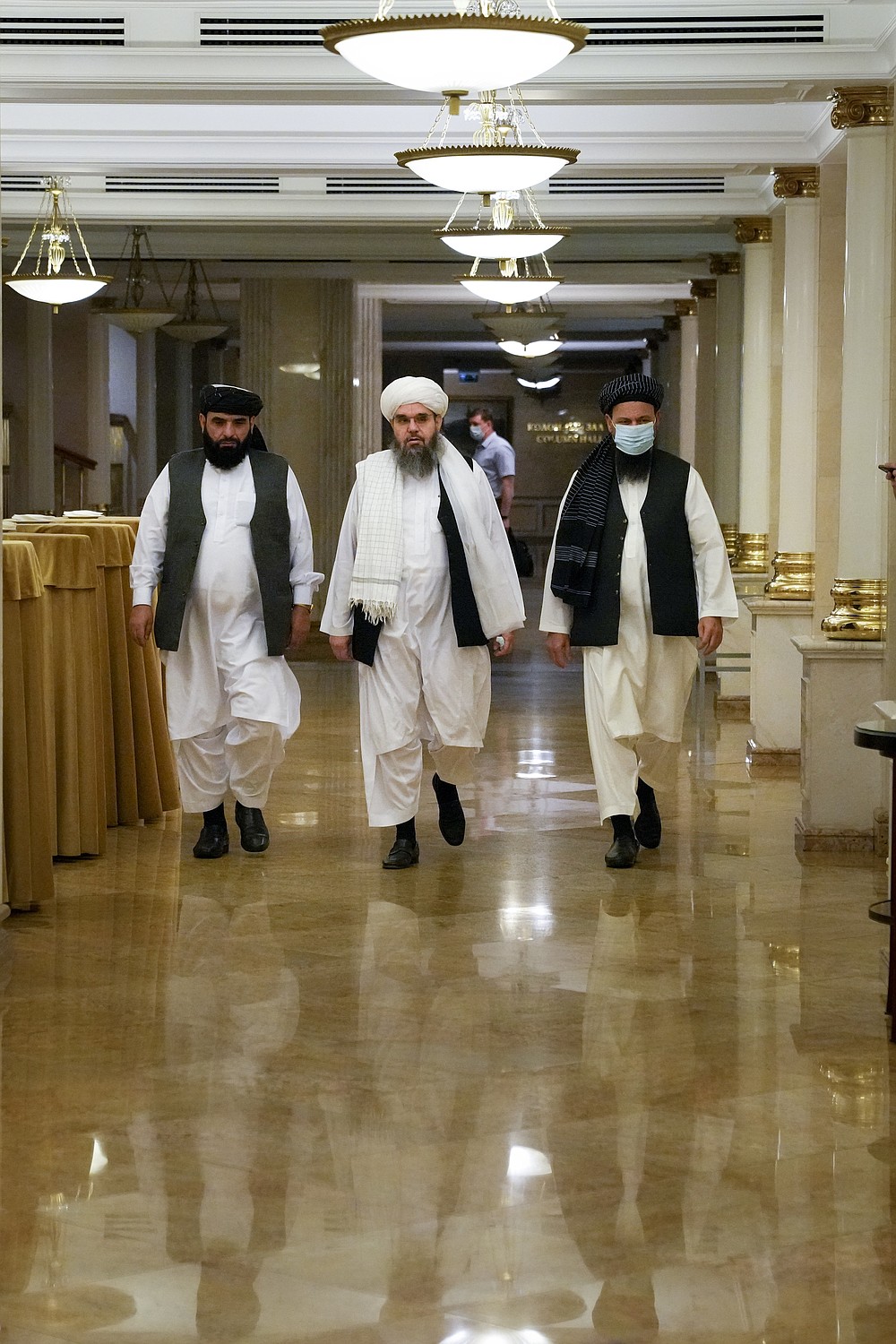 Members of political delegation from the Afghan Taliban's movement Suhil Shaheen, left, Mawlawi Shahabuddin Dilawar, center, and Dr, Mohammad Naim, arrive to attend a news conference in Moscow, Russia, Friday, July 9, 2021. (AP Photo/Alexander Zemlianichenko)