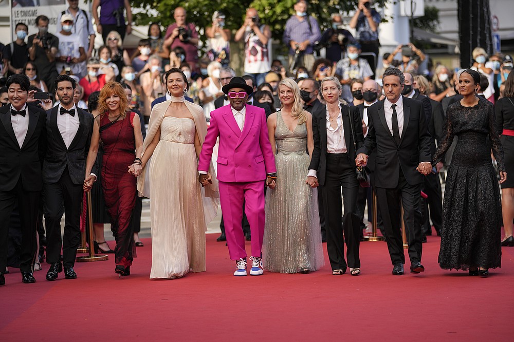 Jury members Kang-Ho Song, from left, Tahar Rahim, Mylene Farmer, Maggie Gyllenhaal, Spike Lee, Melanie Laurent, Jessica Hausner, Kleber Mendonca Filho and Mati Diop pose for photographers upon arrival at the premiere of the film 'Annette' and the opening ceremony of the 74th international film festival, Cannes, southern France, Tuesday, July 6, 2021. (AP Photo/Vadim Ghirda)