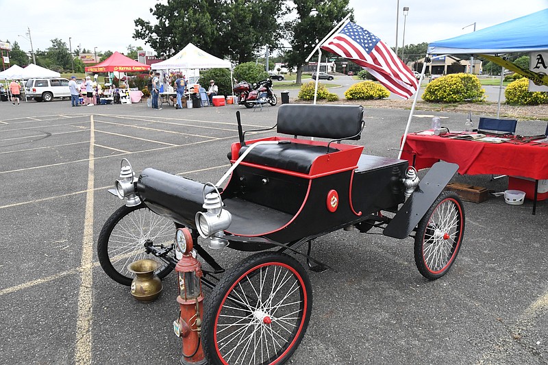 A 1902 Oldsmobile was one of numerous cars, including Mustangs and Cobras, shown Saturday during the 4th Annual Arkansas Honor Ride Car and Bike Show at Uptown Hot Springs, formerly Hot Springs Mall. - Photo by Tanner Newton of The Sentinel-Record