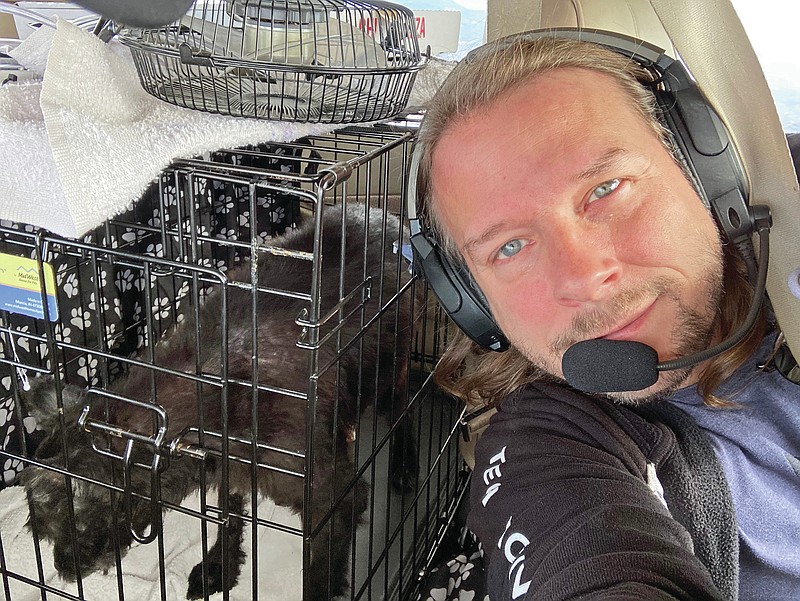 Submitted photo - Jeremy Wade, Razzle's pilot, takes a photo with the dog somewhere between California and New Mexico on July 6. Razzle was returned to his family later that night.