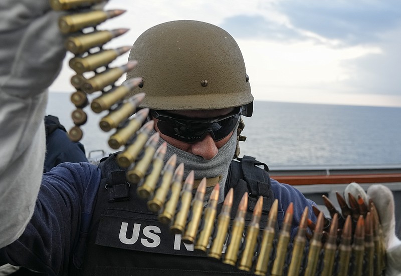 CAPTION CORRECTS DATE US Navy sailor of destroyer USS Ross Nicholas Schwab from Breinero, Minnesota, prepares his machine gun during Sea Breeze 2021 maneuvers, in the Black Sea, Wednesday, July 7, 2021.  Ukraine and NATO have conducted Black Sea drills involving dozens of warships in a two-week show of their strong defense ties and capability following a confrontation between Russia's military forces and a British destroyer off Crimea last month. (AP Photo/Efrem Lukatsky)