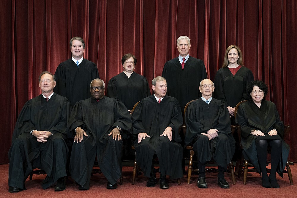 FILE - In this April 23, 2021, file photo, members of the Supreme Court pose for a group photo at the Supreme Court in Washington. Seated from left are Associate Justice Samuel Alito, Associate Justice Clarence Thomas, Chief Justice John Roberts, Associate Justice Stephen Breyer and Associate Justice Sonia Sotomayor, Standing from left are Associate Justice Brett Kavanaugh, Associate Justice Elena Kagan, Associate Justice Neil Gorsuch and Associate Justice Amy Coney Barrett. As congressional Democrats gear up for another bruising legislative push to expand voting rights, much of their attention has quietly focused on a small yet crucial voting bloc with the power to scuttle their plans: the nine Supreme Court justices. (Erin Schaff/The New York Times via AP, Pool)