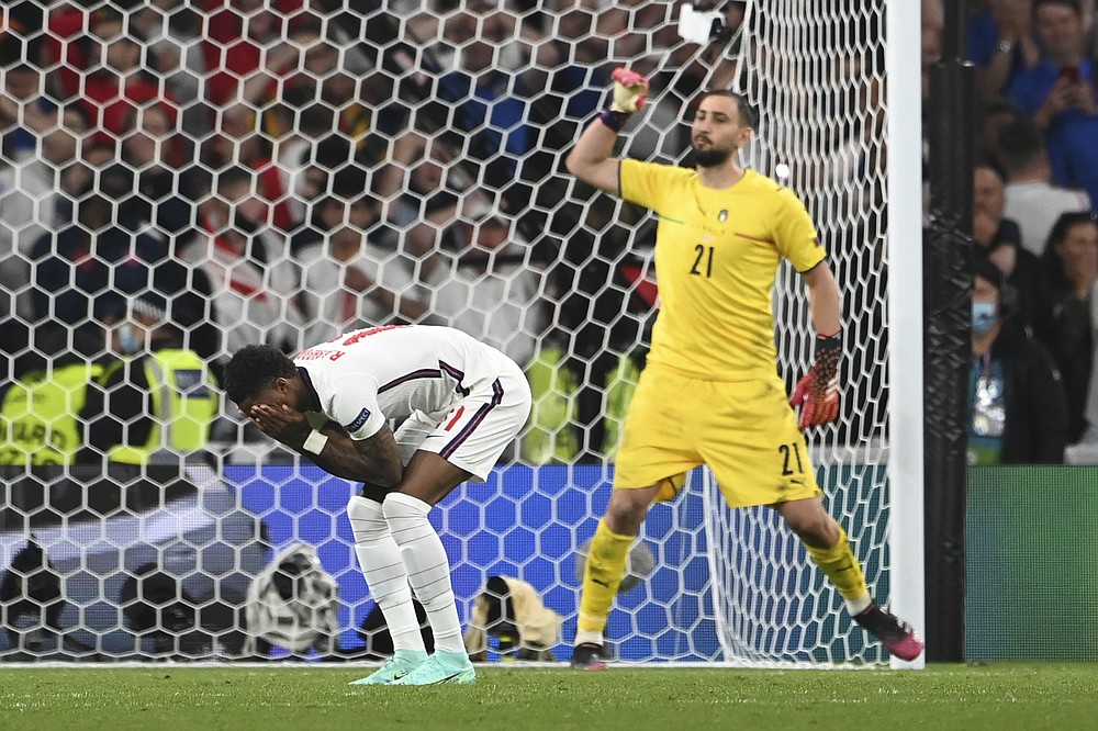 England's Marcus Rashford reacts after missed a penalty shot during the penalty shootout during the Euro 2020 soccer final match between England and Italy at Wembley stadium in London, Sunday, July 11, 2021. (Andy Rain/Pool Photo via AP)