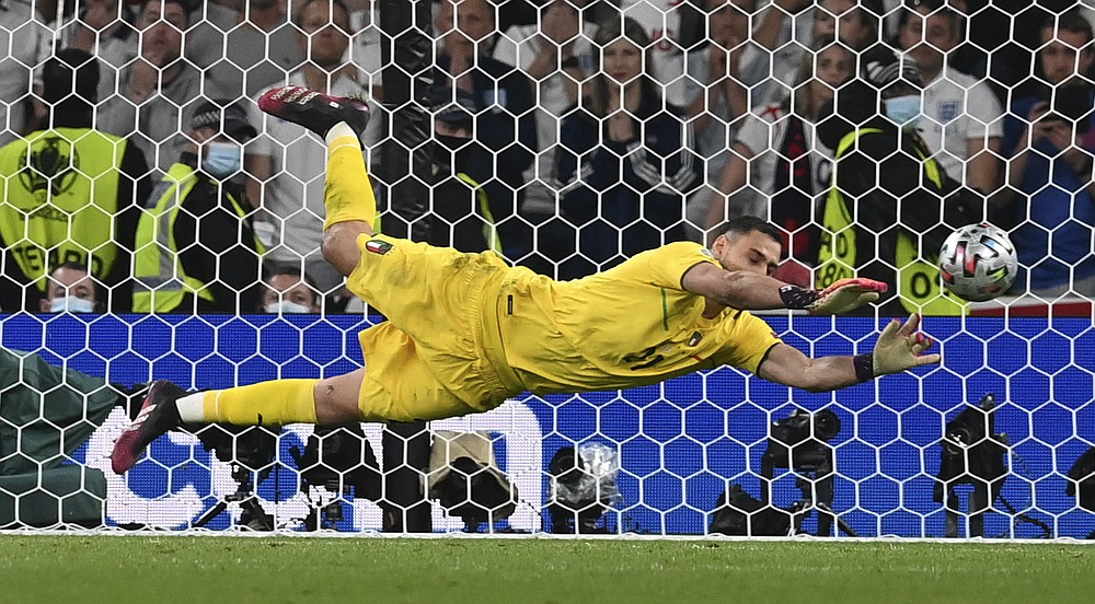  Goalkeeper Gianluigi Donnarumma makes a save as Dani Carvajal looks on during the Euro 2020 semi-final match between Italy and Spain.