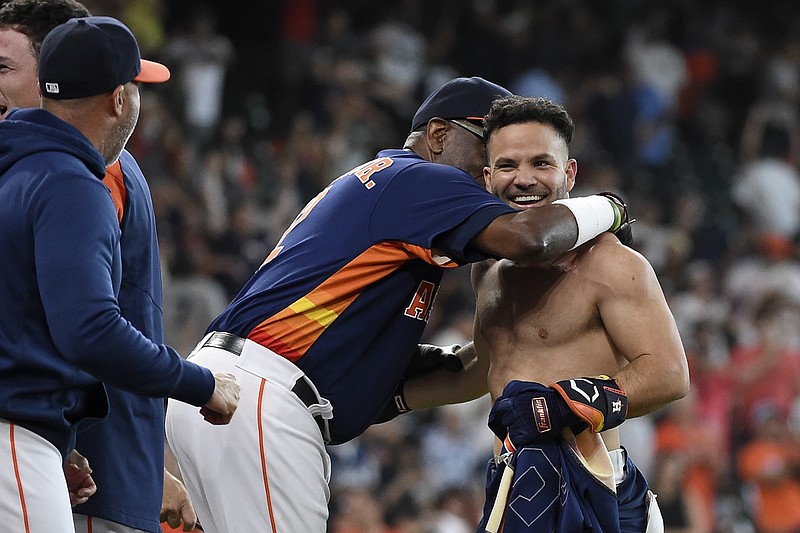 Houston Astros' Jose Altuve, right, celebrates his winning three-run home run with manager Dusty Baker Jr., left, during the ninth inning of a baseball game against the New York Yankees, Sunday, July 11, 2021, in Houston. (AP Photo/Eric Christian Smith)