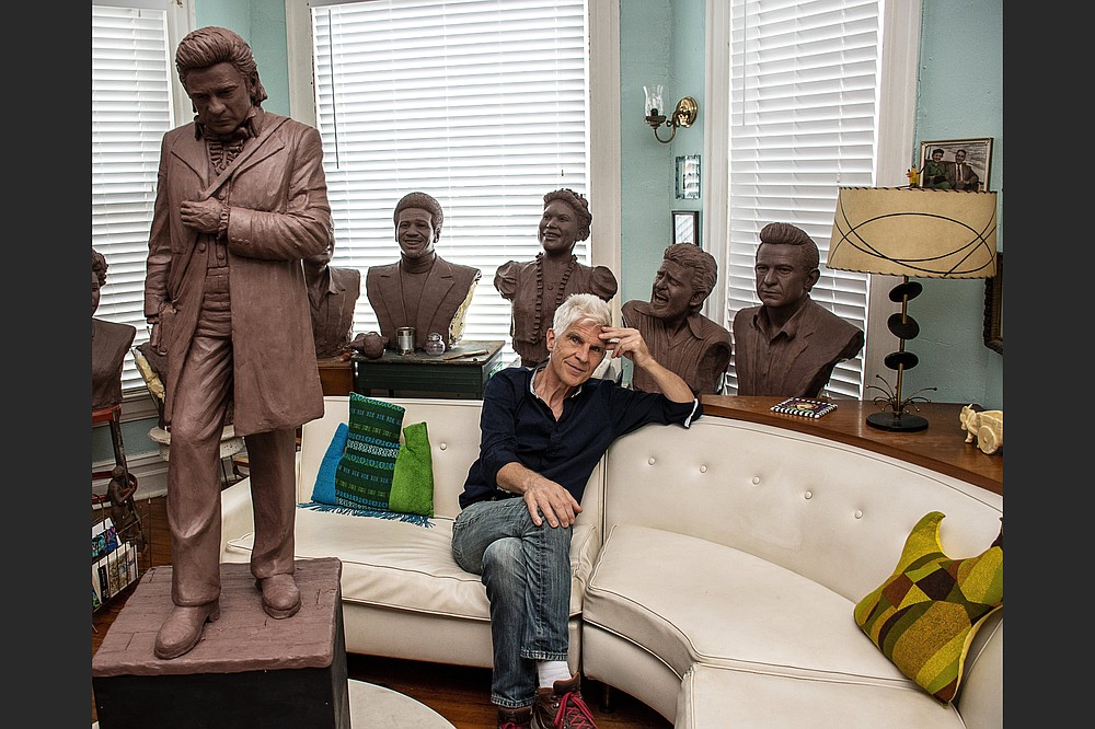 Artist Kevin Kresse sits among clay models he created of Arkansas singing legends — including Johnny Cash, whose statue, created by Kresse and cast in bronze, will be placed in the U.S. Capitol. (Arkansas Democrat-Gazette/Cary Jenkins)