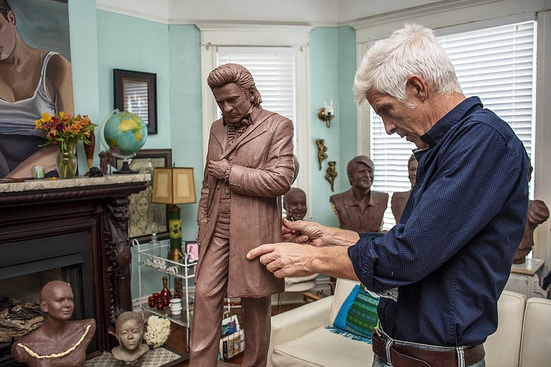 Artist Kevin Kresse makes a few adjustments on his clay model of Johnny Cash at his home. In June 2021, Kresse was selected to create a statue of Cash to reside in the U.S. Capitol — one of two statues representing Arkansas. (Arkansas Democrat-Gazette/Cary Jenkins)