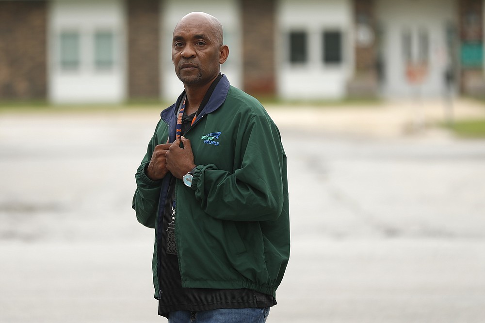 Crosby Smith, care provider at Ludeman Developmental Center, a state home for the developmentally disabled, poses for a portrait near the center premise, Thursday, July 8, 2021 in Park Forest, Ill. Smith and his fiancee were among numerous staff and residents at the Ludeman Developmental Center who contracted the virus last year. He said the hazard money helped pay down credit cards and avoid further debt when buying clothing and shoes. (AP Photo/Shafkat Anowar)