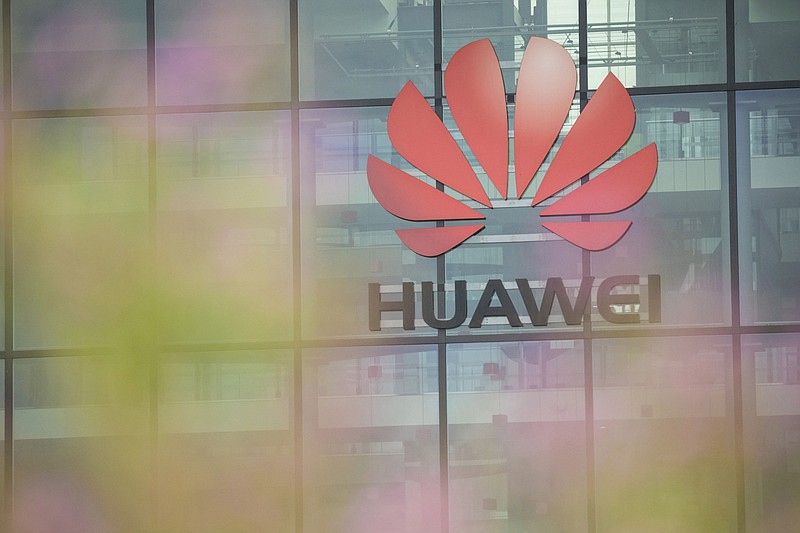 A Huawei Technologies logo hangs above the entrance to the company's offices in Reading, U.K., on July 13, 2020. MUST CREDIT: Bloomberg photo by Jason Alden.