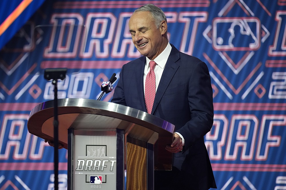 MLB Commissioner Rob Manfred reacts as he is booed by fans during the first round of the 2021 MLB baseball draft, Sunday, July 11, 2021, in Denver. (AP Photo/David Zalubowski)