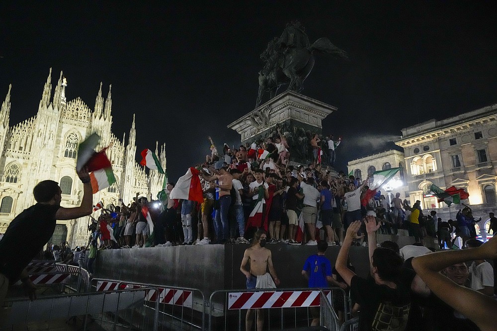 I tifosi italiani festeggiano davanti al Duomo di Milano, lunedì 12 luglio 2021, dopo che l'Italia ha battuto l'Inghilterra per vincere gli Europei di calcio 2020 nella partita finale disputata allo stadio di Wembley a Londra.  L'Italia ha battuto l'Inghilterra 3-2 ai rigori dopo l'1-1.  (Foto AP/Luca Bruno)