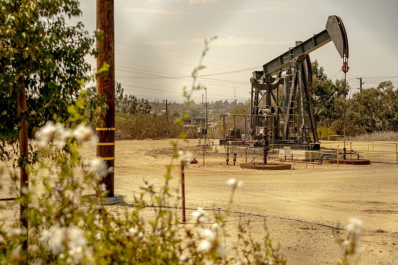 An oil derrick pump operates at the Inglewood Oil Field in Culver City, Calif., on July 11, 2021. MUST CREDIT: Bloomberg photo by Kyle Grillot.