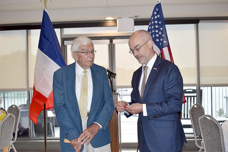 Rachel Dickerson/The Weekly Vista French Consul General Alexis Andres, right, presents the Legion of Honour medal to Kenneth "KB" Smith of Bella Vista.