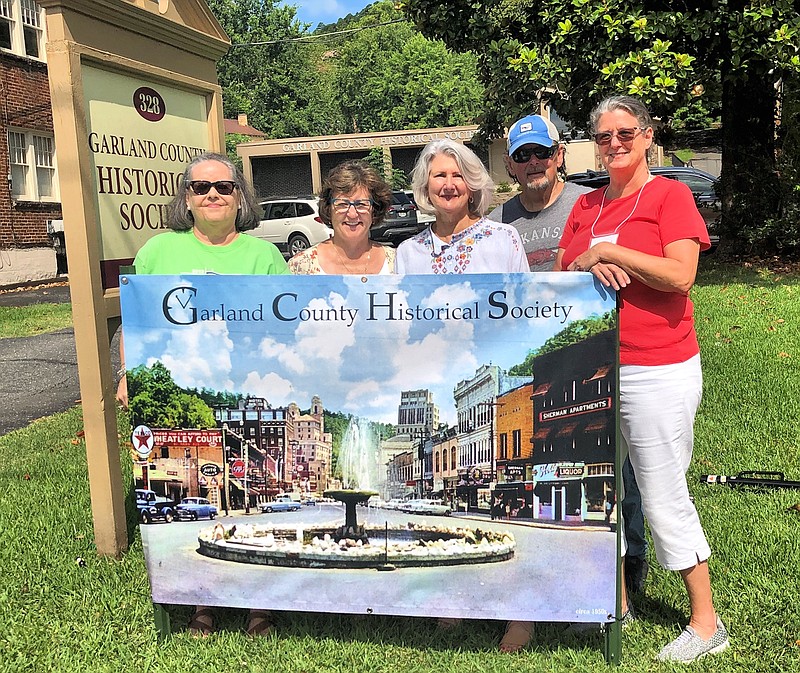 From left are Garland County Historical Society Vice President Bitty Martin, volunteer Cindy Rogers, President Julie Brenner Nix, and volunteers Duke Nix, and Karen Blohm, with the newly installed crystal fountain sign in front of the Historical Society building at 328 Quapaw. The crystal fountain was at the Central, Whittington, and Park avenues junction from 1952 until 1972. - Submitted photo