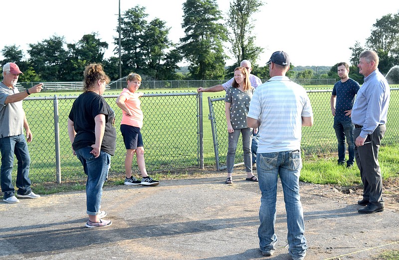 Westside Eagle Observer/MIKE ECKELS
Ike Owens (far left) points out where he thinks the new bleachers should be placed to his fellow school board members during a tour of  Bulldog Stadium in Decatur July 13. The new bleachers will be placed against the fence that divides the football field and fan area.