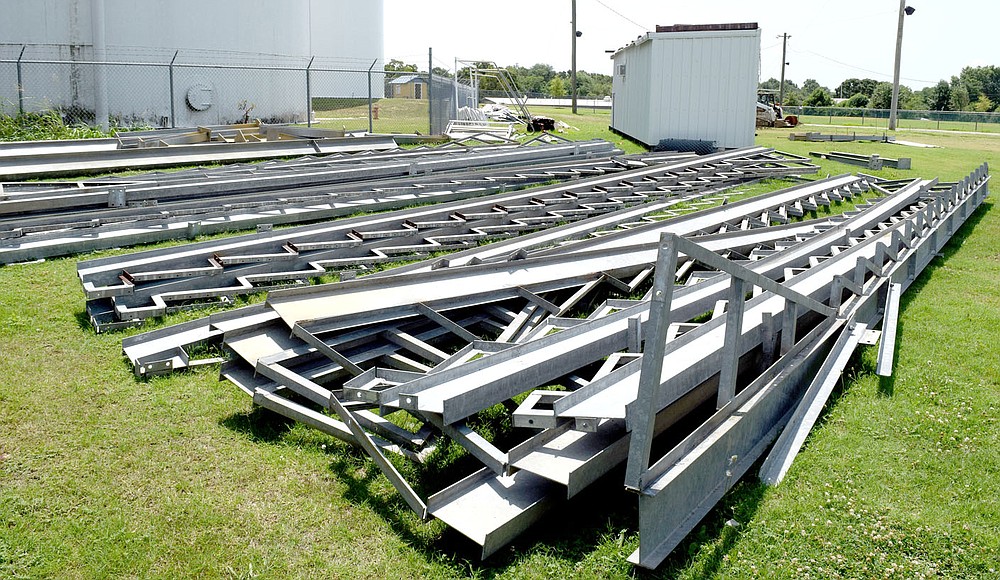 Westside Eagle Observer/MIKE ECKELS
A metal jigsaw puzzle of seat supports occupies the ground near the old bleachers at Bulldog Stadium in Decatur July 14. Once these pieces are put together, they will form the new bleachers at Bulldog Stadium which will have nearly double the capacity of the old wooden structure.