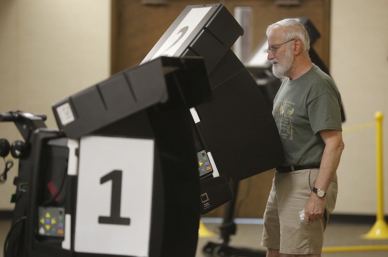 Edward Gbur (cq) votes Tuesday, July 13, 2021 at the Johnson Church of Christ in Johnson. Johnson residents well decide wether to OK a temporary 1% sales tax to back a $7.3 million street bond issue, according to the city's website. Check out nwaonline.com/210714Daily/ and nwadg.com/photos for a photo gallery.(NWA Democrat-Gazette/David Gottschalk)