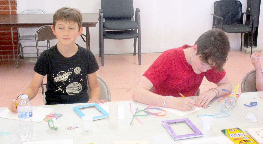 Marc Hayot/Herald-Leader Brian Thompson (left), takes a break from his project while Emery Case works diligently on hers. Thompson and Case were one of two kids who participated in the senior art program held by the Parks and Recreation division the week of the July 12.