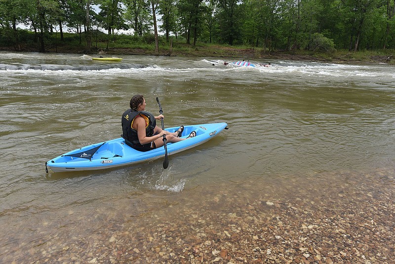 Every sport has its superstitions, even kayaking. Quincy McElyea of Fort Smith shoves off May 22 2021 to paddle with friends on the Illinois River at the Siloam Springs Kayak Park south of town. 
(NWA Democrat-Gazette/Flip Putthoff)