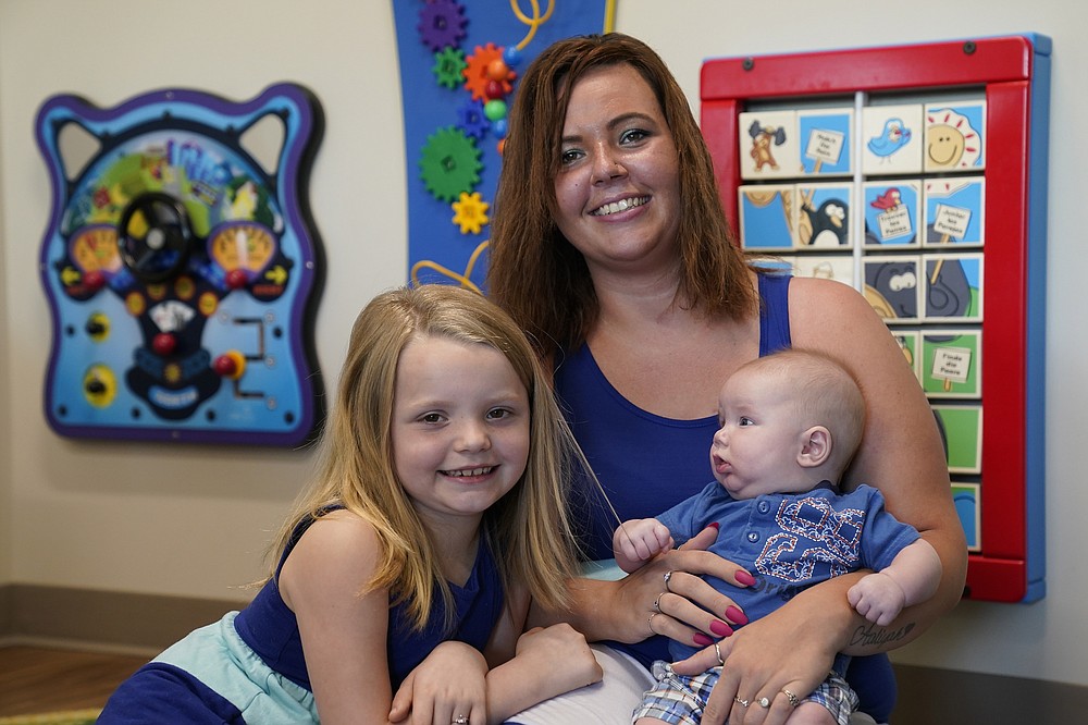 Megan Sims is shown with her children, 3 month-old Christian and Aaliyah, 7, in Carrboro, N.C., Tuesday, July 13, 2021. Sims couldn't stop using drugs during the pandemic, even as she discovered she was pregnant. Through word of mouth, Sims discovered Horizons, a substance use disorder treatment program at the University of North Carolina's School of Medicine that is designed specifically for pregnant women and mothers. "Horizons saved my life." Sims said. (AP Photo/Gerry Broome)