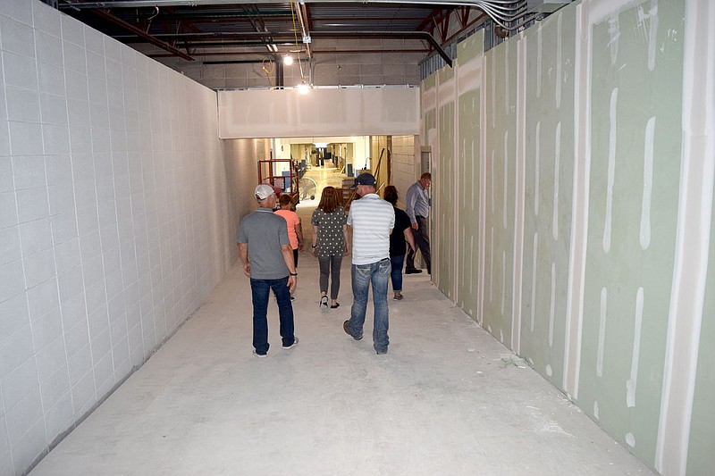 Westside Eagle Observer/MIKE ECKELS
Decatur School Board members make their way down the main hallway into the old part of Decatur High School July 13 during a construction progress walk though. This hallway runs the entire length of the high school and will give students and faculty the ability to walk from class to class without going into the outside elements.