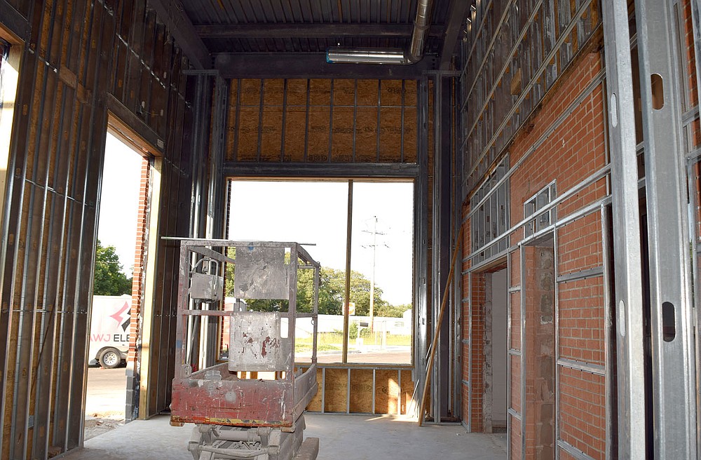 Westside Eagle Observer/MIKE ECKELS
What once was an outside covered walkway will soon be an inside hallway as the main entrance to Decatur High School inches closer to completion July 13. The Decatur school board toured the facility to view the progress made on the new high school renovation project.