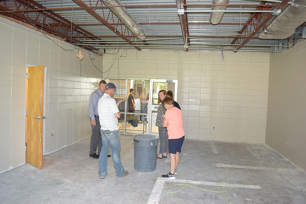 Westside Eagle Observer/MIKE ECKELS
The old high school office will soon have a completely different mission as members of the Decatur school board review the progress made on the high school renovation project July 13. The old office will serve as a small classroom area when the school opens its doors in August.