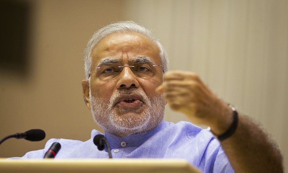 FILE - In this August 28, 2014 file photo, Indian Prime Minister Narendra Modi speaks during the launch of a campaign to open millions of bank accounts for poor Indians in New Delhi, India. India's new social media regulations are at the heart of a deadlock that places digital platforms like Twitter and Facebook under direct government scrutiny. The new rules, in the works for years and announced in February 2021, apply to social media companies, streaming platforms and digital news publishers. The new rules make it easier for the government to order social media platforms with more than 5 million users to remove content deemed illegal. Critics say Modi's Hindu nationalist government is imposing what they call a climate of