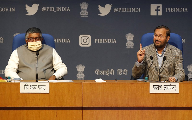 FILE - In this Thursday, Feb. 25, 2021, file photo, India's Information Technology Minister Ravi Shankar Prasad, left, and Information and Broadcasting Minister Prakash Javadekar address a press conference announcing new regulations for social media companies and digital streaming websites in New Delhi, India. It began in February with a tweet by pop star Rihanna that sparked widespread condemnation of Indian Prime Minister Narendra Modi's handling of massive farmer protests near the capital, souring an already troubled relationship between the government and Twitter. (AP Photo/Manish Swarup, File)