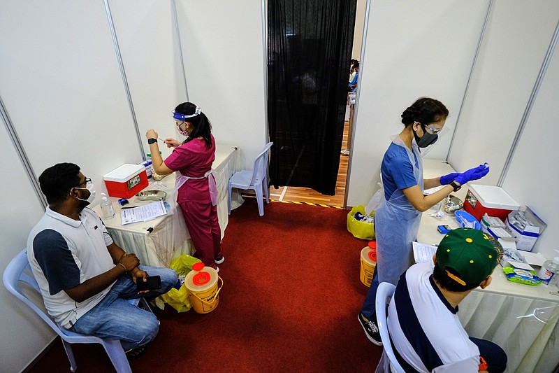 Health workers prepare doses of Covid-19 vaccine for sailors and port workers in Port Klang, Malaysia, on June 25, 2021. MUST CREDIT: Bloomberg photo by Samsul Said.